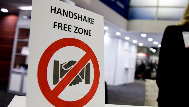 Door sign that states "Handshake free zone".