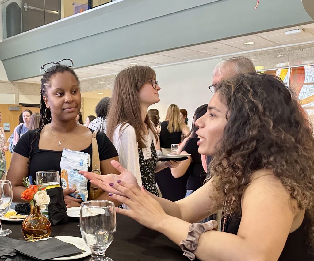 Students and alumni at a  networking reception.