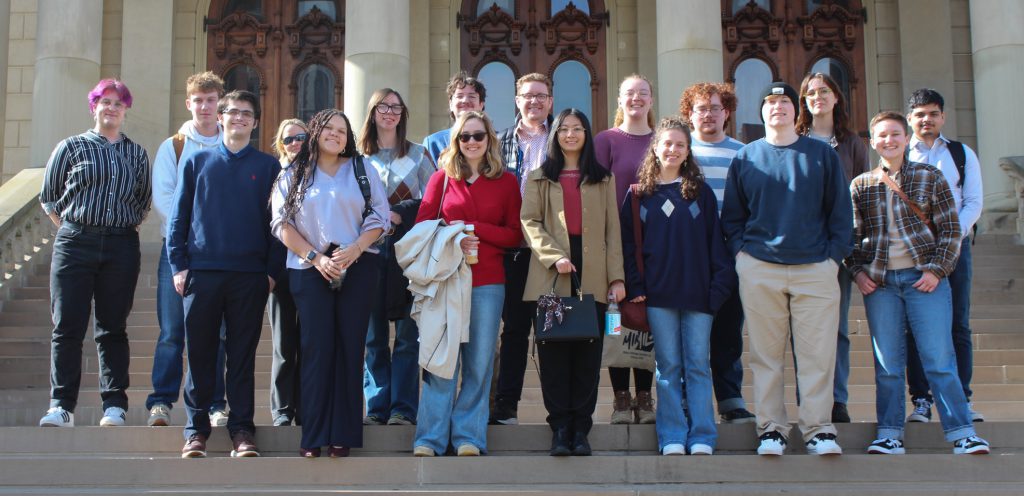 Dr. Berry posing with students on the Michigan Capitol steps in Lansing